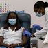 Sandra Lindsay(left), a nurse at Long Island Jewish Medical Center, is inoculated with the Covid-19 vaccine.