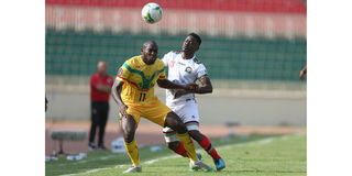 Mali's forward Ibrahima Kone vies for the ball with Kenya's defender Eric Ouma