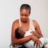 Woman cuddles baby 