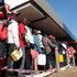 People queue to buy fuel at a filling station.