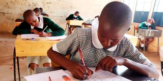 Pupils sitting a KCPE mathematics paper.