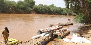 Traders use rafts in River Daua