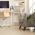 Background image of comfy grey armchair in a cosy nook of a modern Scandinavian home.