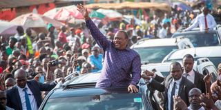 Former President Uhuru Kenyatta acknowledges greetings from Luanda and Kisumu City resident
