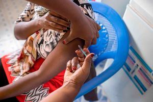 A woman is inoculated with a Covid-19 vaccine at Oltepesi Dispensary in Kajiado, Kenya