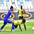 Uganda captain Emmanuel Okwi (right) is tackled by a Tanzanian player