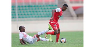 Ulinzi Stars defender Njoroge Wilfred (left) vies for the ball with Kenya Police midfielder Clifton Miheso