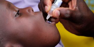 health officer administers polio vaccines