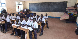 A lesson going on, with and mattresses inside a classroom at Kapindasum Primary School in Baringo South Constituency