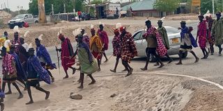 Turkana residents donned in traditional regalia arrive in Lodwar town