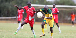 Mathare United forward Timothy Otieno (right) vies for the ball with SS Assad defender Juma Mwajao
