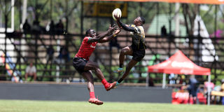Kenya Shujaa's Herman Humwa (left) vies for an aerial ball
