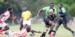 Kabras Sugar's George Nyambua (right) goes past Nondescript's Ian Omoke (down)