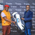 NCBA Group Managing Director John Gachora awards Kenneth Mburu,