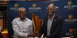 Machakos Golf Club's Charles Kithuku receives the ICEALION King of the course trophy from ICEALION CEO Philip Lopokoiyit