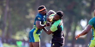 Walter Okoth (right) of Kabras Sugar vies with Felix Ojow of KCB