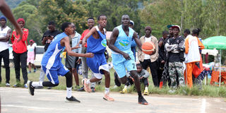 Dagoretti High School's Telema Mogi vies with Imran Omar of Sabulney High School