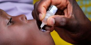 health officer administers polio vaccines
