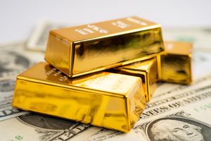 Gold bar on US dollar banknotes money
